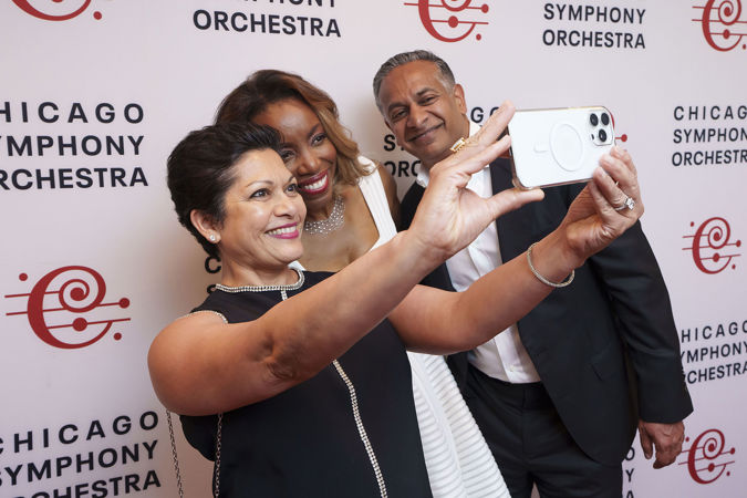 Singer Heather Headley takes photos with two fans postconcert