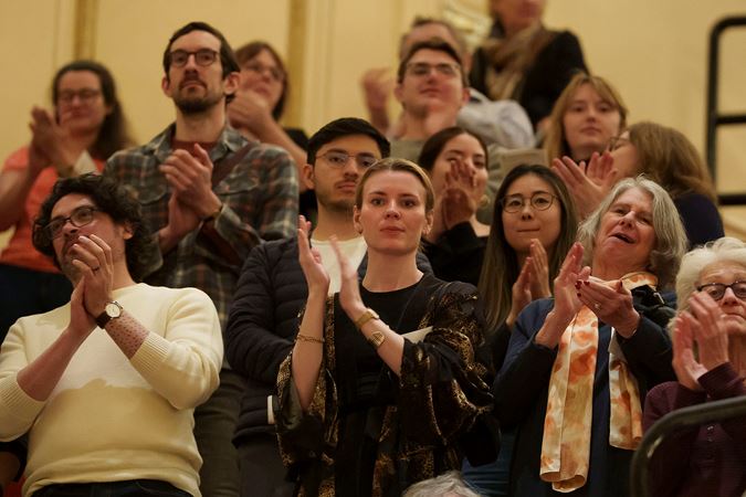 Group shot of audience members clapping from the Lower Balcony