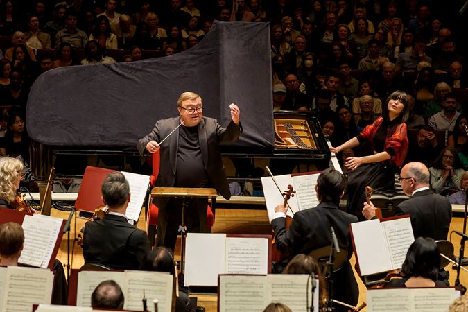 Action shot of pianist Alice Sara Ott and conductor Mikko Franck on stage