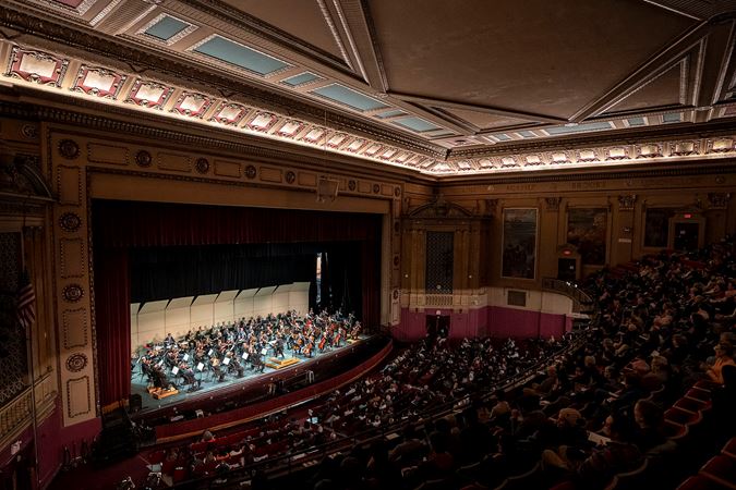 a full view of the auditorium at Morton East High School while the orchestra plays
