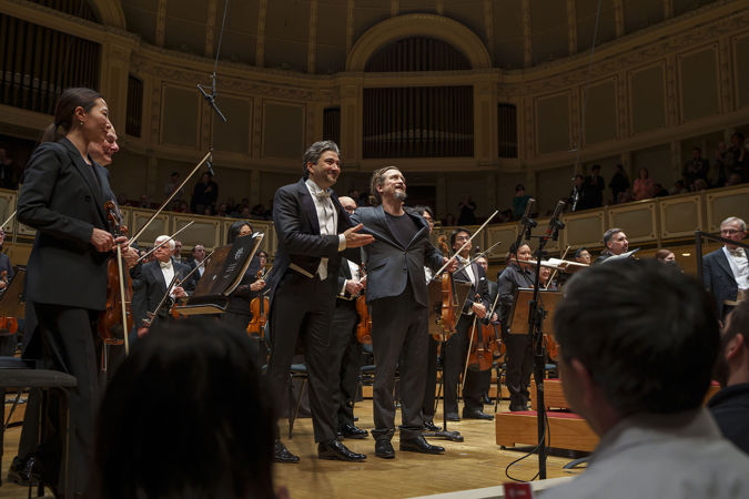 conductor David Afkham and guest violinist Christian Tetzlaff bow