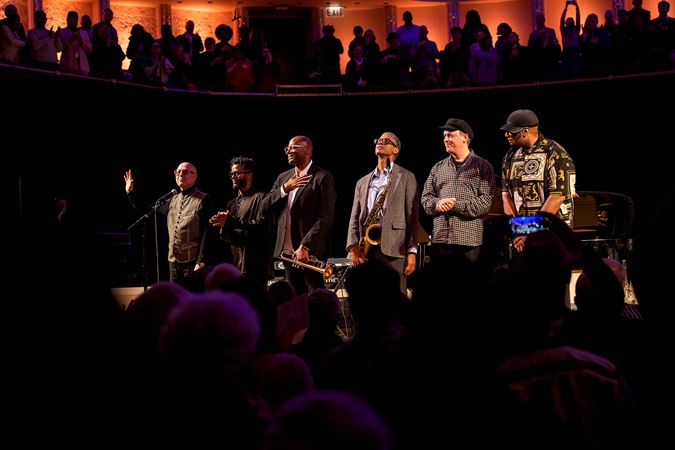 the Unlimited Miles ensemble takes a bow, as the audience rises for a standing ovation