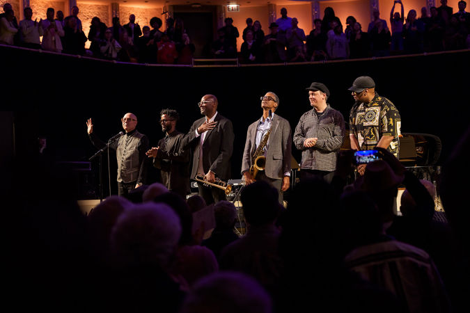 the Unlimited Miles ensemble takes a bow, as the audience rises for a standing ovation