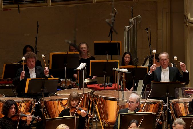 An action shot of CSO percussions Vadim Karpinos and David Herbert each playing the timpani