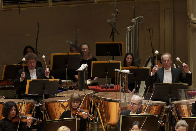 An action shot of CSO percussions Vadim Karpinos and David Herbert each playing the timpani
