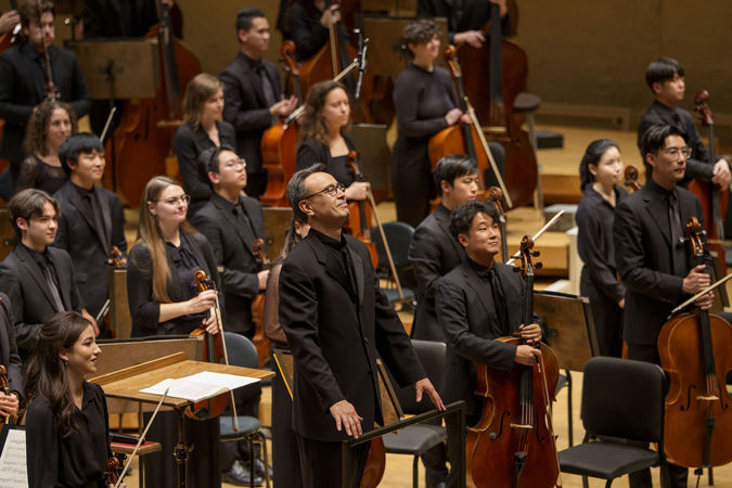 Group shot of principal conductor Ken-David Masur and Civic musicians bowing