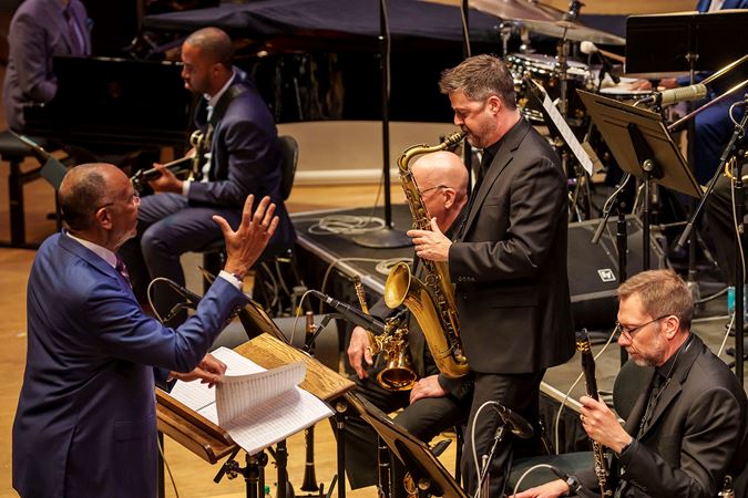 John Clayton directs as Chicago Jazz Orchestra lead alto saxophone John Wojciechowski plays a solo
