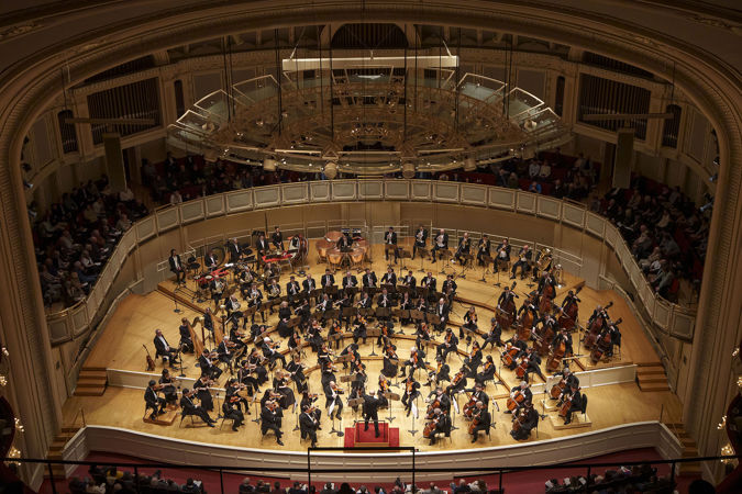 point of view from the gallery, the highest seating section in Orchestra Hall, looking down over the orchestra mid-performance