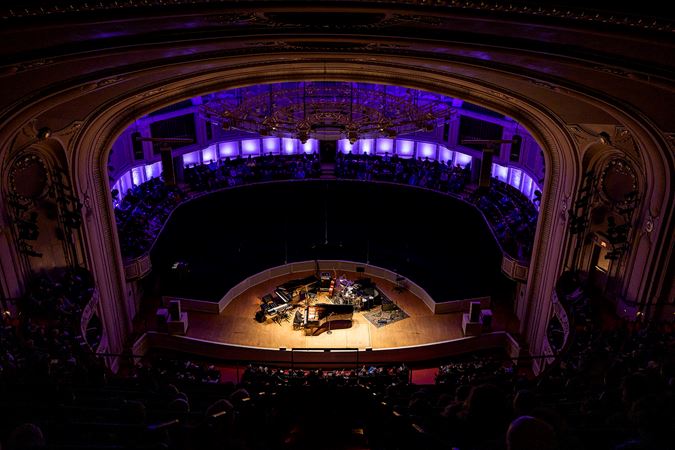 a wide shot from the balcony of pianist Gonzalo Rubalcaba performing solo on stage