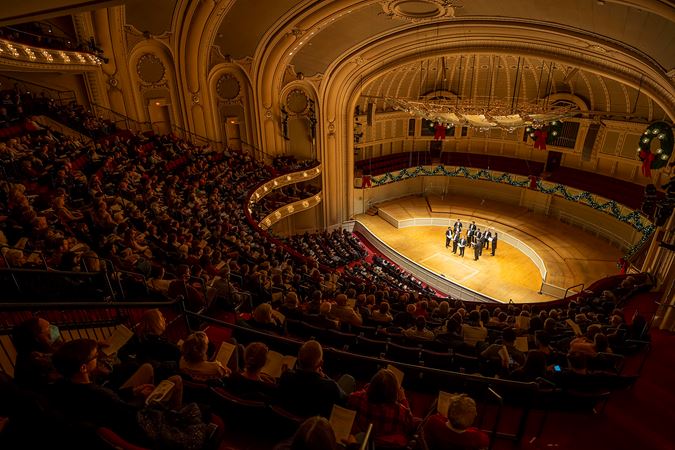 the audience in the balcony overlooks Chanticleer performing