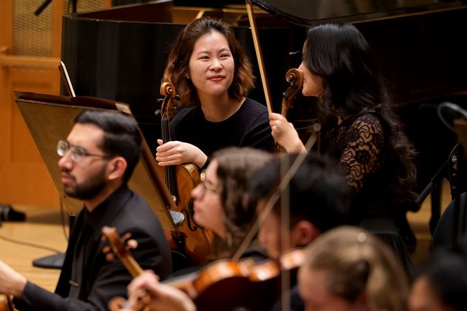 Closeup Of Two Civic Violinists On Stage Before The Concert