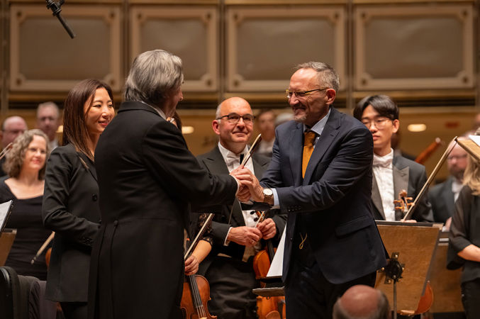 conductor shaking hands with composer