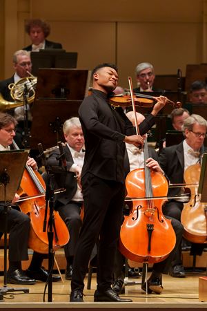 Closeup action shot of violinist Randall Goosby performing on stage with the CSO