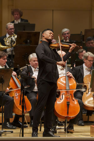Closeup action shot of violinist Randall Goosby performing on stage with the CSO
