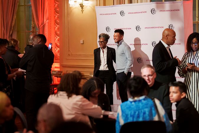 Violinist Randall Goosby taking photos with CSO African American Network members at a Meet-and-Greet postconcert event in Grainger Ballroom