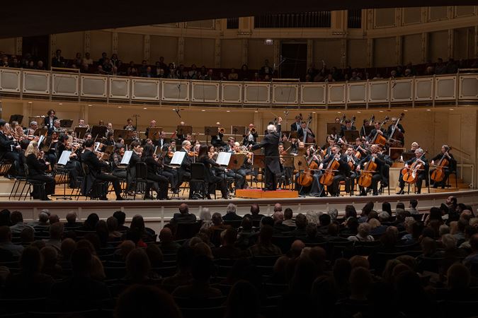 wide shot of Janowski conducting the Orchestra