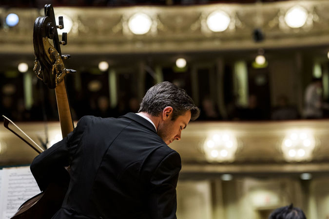 CSO bass Ian Hallas warms up on stage