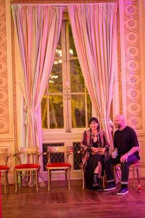 Two Underground attendees sitting down and observing from the sidelines in Grainger Ballroom
