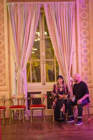 Two Underground attendees sitting down and observing from the sidelines in Grainger Ballroom