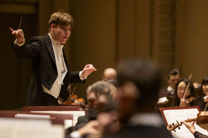 Mäkelä gestures to the string section during the performance
