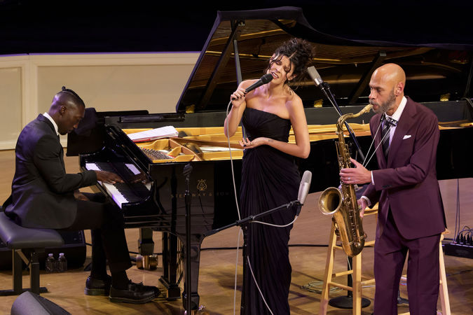 Closeup shot of saxophonist Joshua Redman, singer Gabrielle Cavassa and pianist Paul Cornish on stage