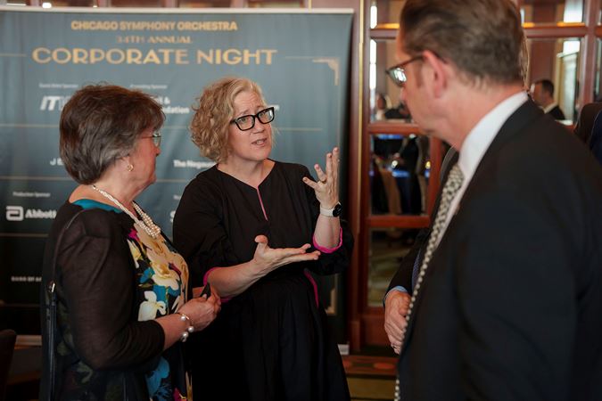 A few attendees chatting in Club 9 during a Corporate Night reception