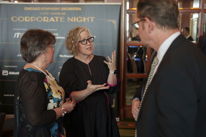 A few attendees chatting in Club 9 during a Corporate Night reception