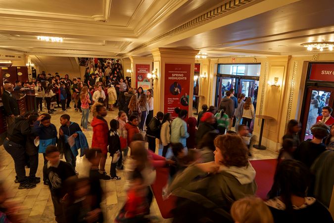 A wide shot of the Symphony Center's main floor hall packed with Chicagoland student and educators