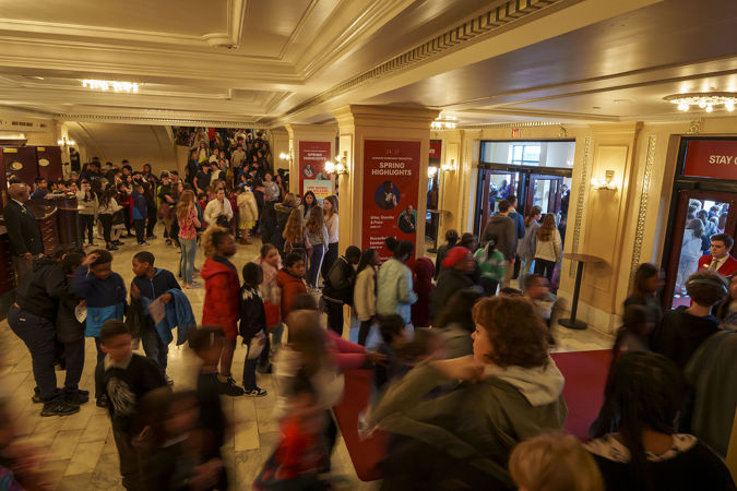 A wide shot of the Symphony Center's main floor hall packed with Chicagoland student and educators