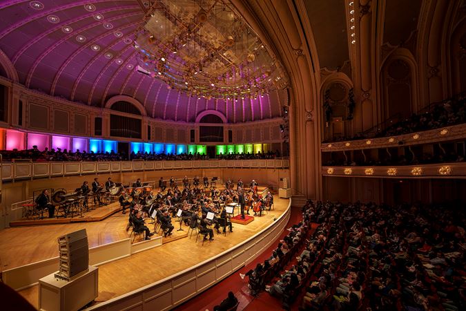 A wide shot of conductor Thomas Wilkins leading members of the CSO at Community Pride, a CSO for Kids concert