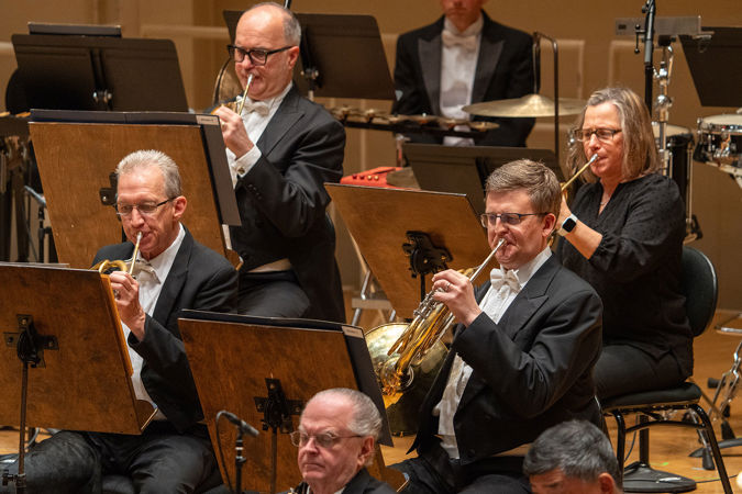 Group shot of CSO horns on stage