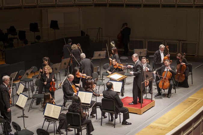 A few CSO musicians walk off stage as Harry Bicket leads the CSO in Haydn's Farewell Symphony