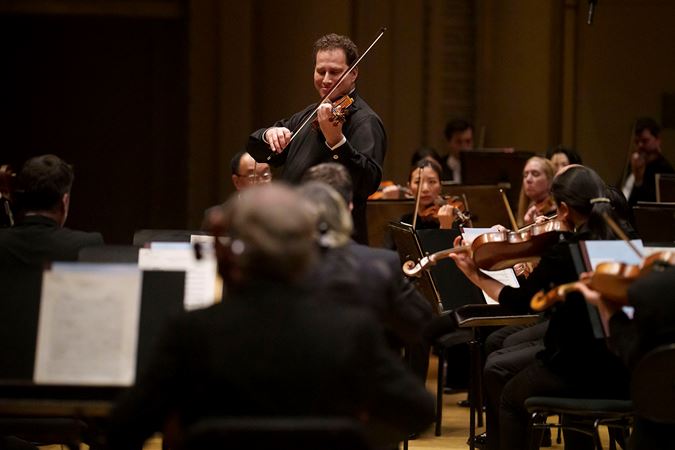 Violinist Nikolaj Szeps-Znaider performing on stage with the Chicago Symphony Orchestra