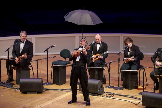 the umbrella makes a return, this time balanced impressively on Guy Bellingham's forehead as he plays his instrument