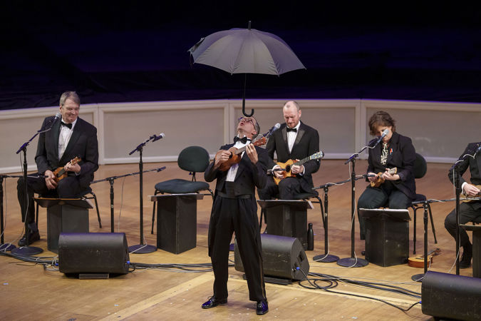 the umbrella makes a return, this time balanced impressively on Guy Bellingham's forehead as he plays his instrument