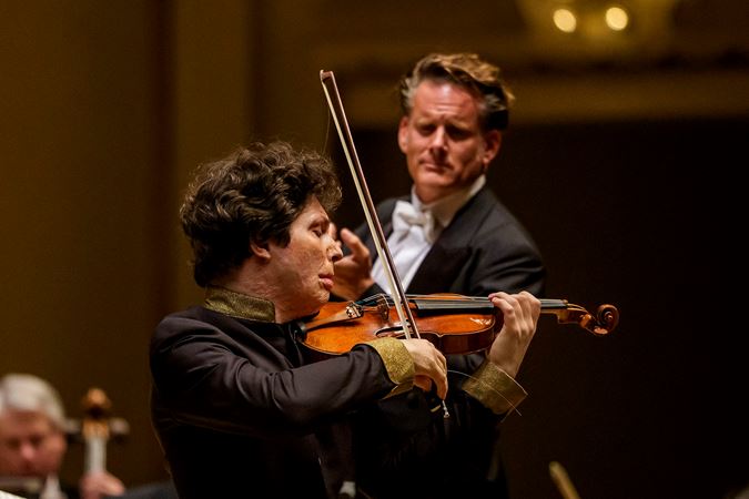 Closeup action shot of violinist Augustin Hadelich on stage
